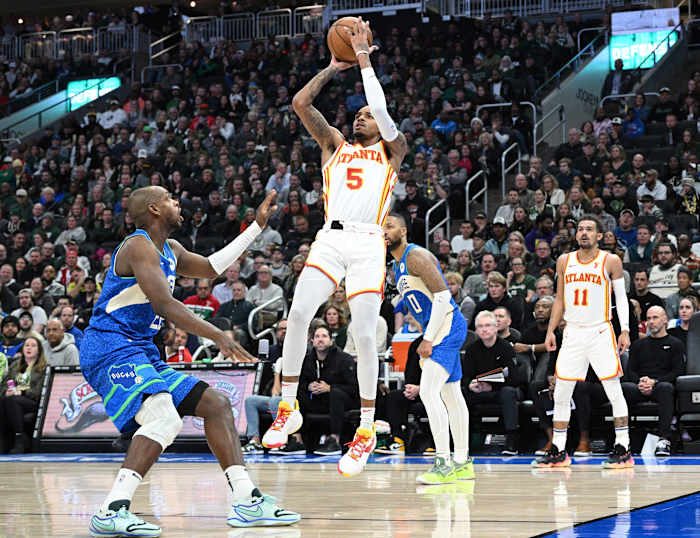 Atlanta Hawks guard Dejounte Murray (5) puts up a shot against Milwaukee Bucks forward Khris Middleton (22) in the second half at Fiserv Forum.